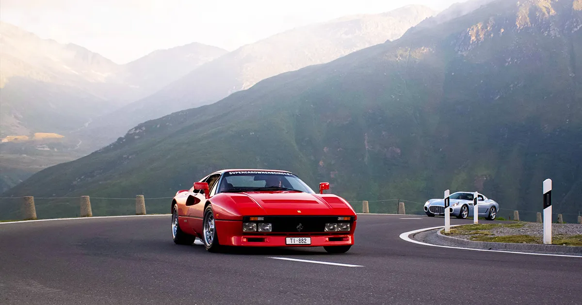 Ferrari's classic 288 GTO is aging beautifully. A red Ferrari 288 GTO rounds a corner on a country road